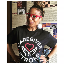 Load image into Gallery viewer, Advocate Dawnita Michelle' Brown in her Caregiver Strong t-shirt.