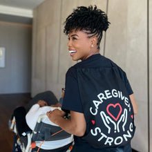 Load image into Gallery viewer, Actress Brandee Evans wearing a &quot;Caregiver Strong&quot; tote bag.
